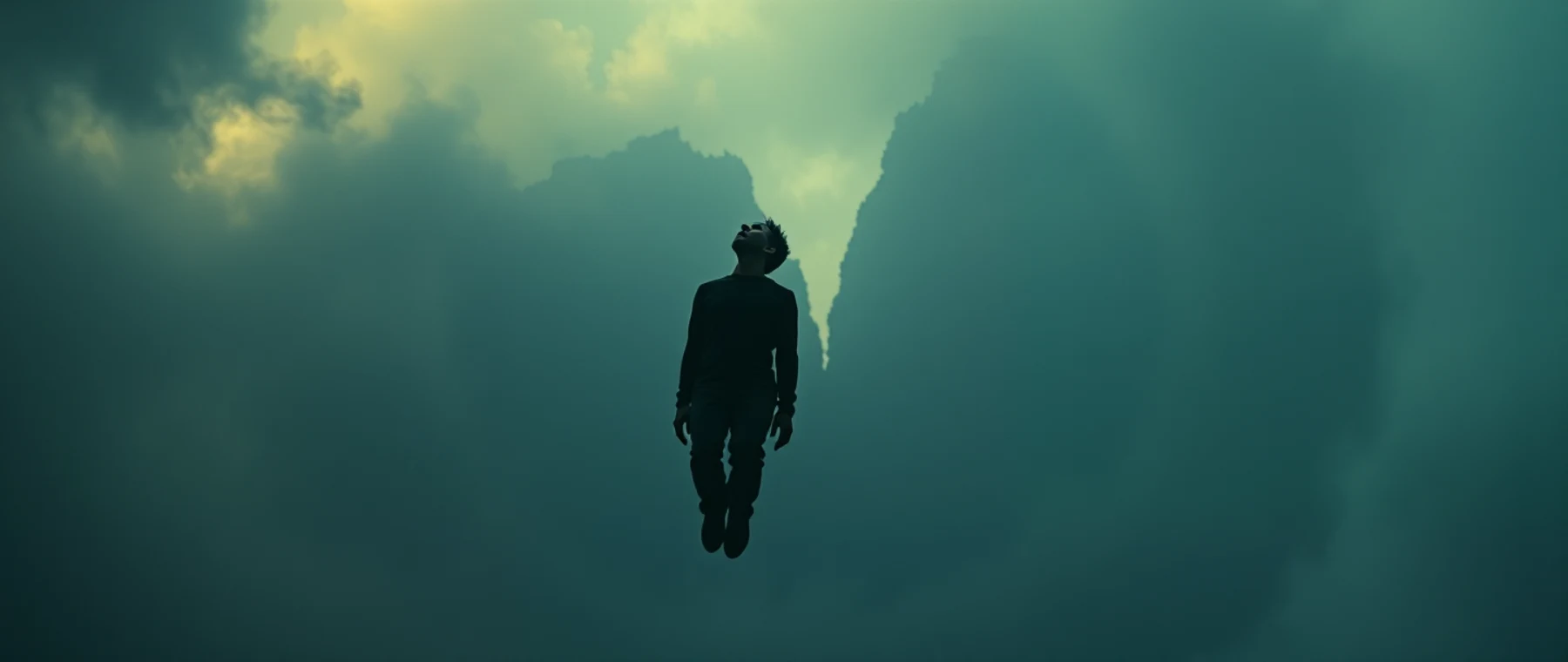 A figure suspended inside a vortex of cloud.